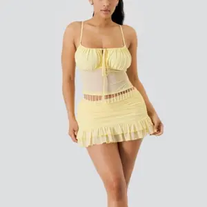 Sariah Set - 95% POLYESTER 5% SPANDEX  90% POLYESTER 10% SPANDEX    Two-piece set featuring a cami-style top with a gathered bust, adjustable straps, and a sheer mesh waist panel accented with delicate hanging chain details for a statement finish.