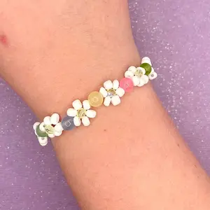 Beaded Flower Bracelet. Handmade with white flowers and pink, yellow, blue, and green.