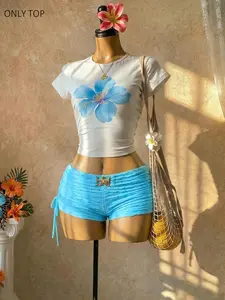 Women's blue hibiscus print crop top and babydoll style Y2K Casual fitted crop top, can be paired with pleated side-tie shorts. A stylish beach streetwear outfit, perfect for summer and vacation looks. TikTok trend: comfortable, tropical streetwear.