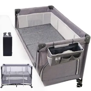 This multi-functional bedside crib/bassin is suitable for infants and newborns. It features a soft mattress, storage basket, and mosquito net. It's easy to fold, has three height adjustments, is easy to move, and has breathable mesh fabric.