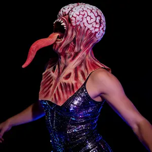 New bizarre horror mutant monster latex mask featuring an extremely terrifying swollen monster face, extra-long red tongue drooping down, black vein carvings; a Halloween escape room prank prop and horror party role-play piece; one size fits most adults.