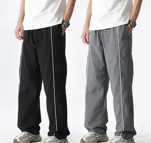 Men’s American high-street paratrooper pants for summer — loose straight-leg casual athletic trousers with side stripes and a drawstring, featuring a drapey feel.