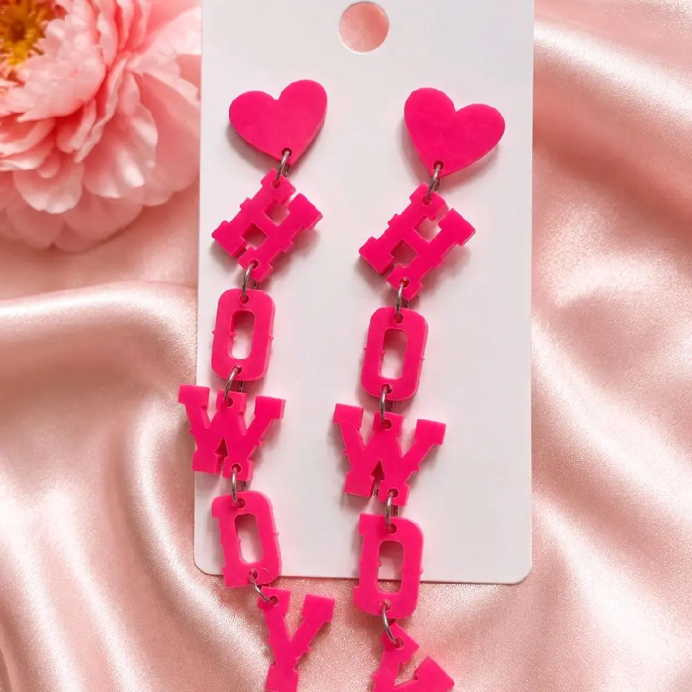 Make a statement with these adorable hot pink HOWDY Earrings!  Featuring heart-shaped studs and playful dangling letters, these earrings bring the perfect pop of pink to any outfit.