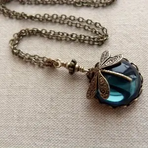 Vintage Victorian-style handmade necklace featuring a moon and dragonfly motif with a white faux opal pendant; jewelry chains; vintage jewelry