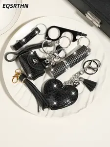 Black and silver full diamond keychain set with an edgy and high-end vibe. Complete with a heart pendant, bottle opener and lipstick case, it's a must-have accessory for every sweet and cool girl's bag.