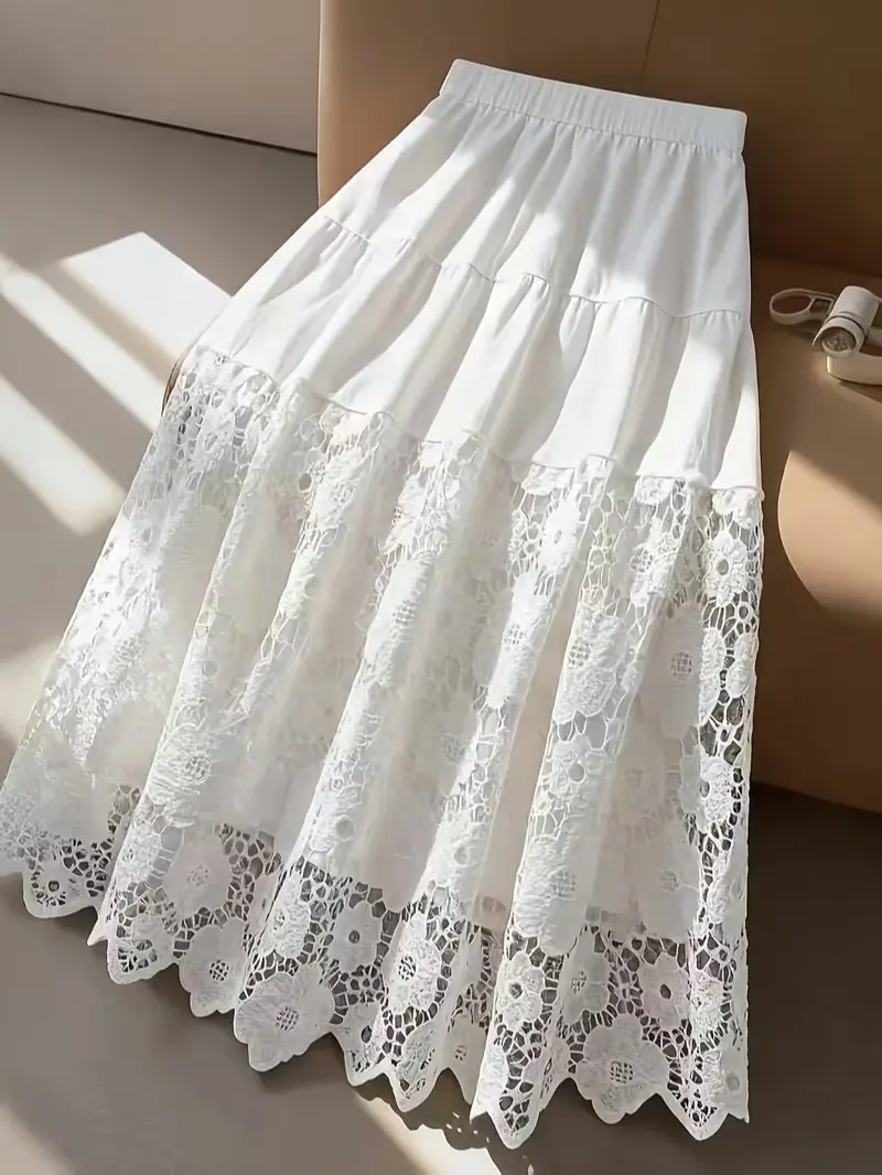An elegant, graceful, and gentle-style A-line midi skirt featuring a high waist and cut-out lace paneling.