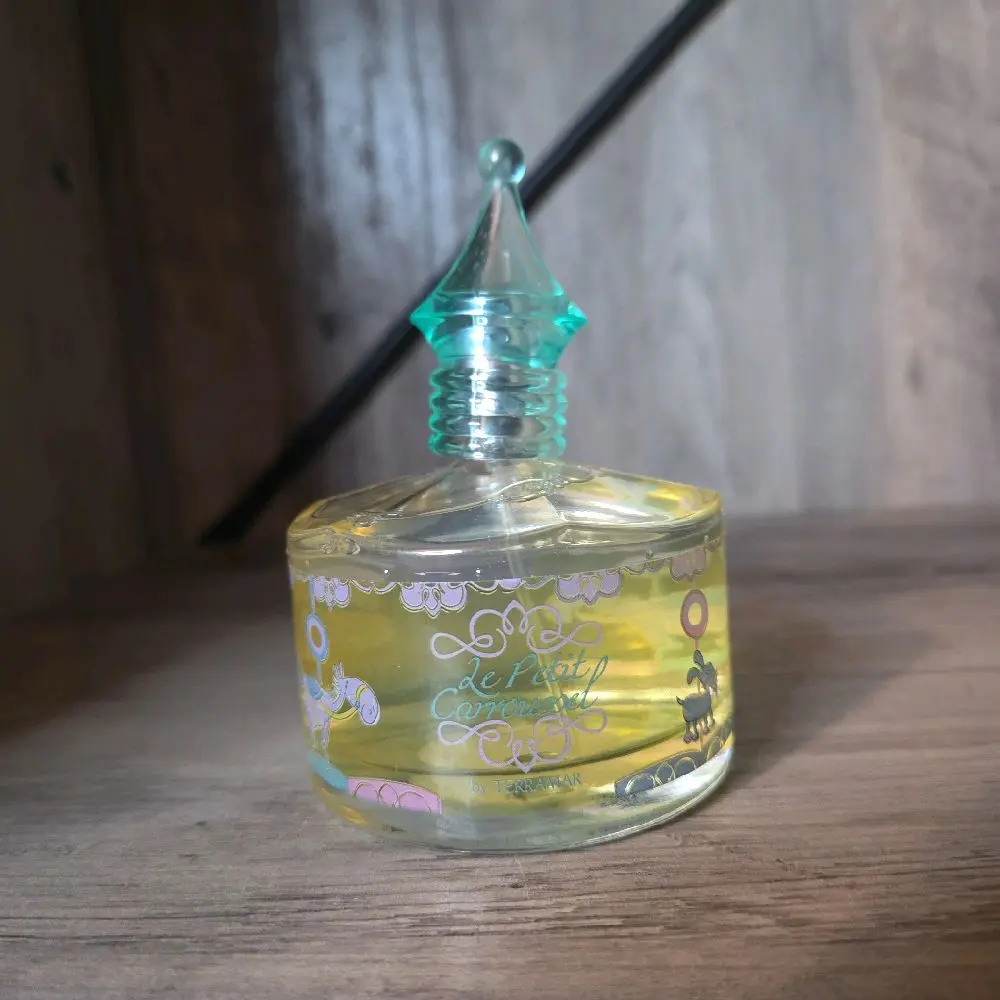 Le Petit Carroussel Perfume - Elegant Glass Bottle with Unique Cap Design for Aromatic Appeal