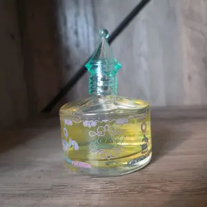 Le Petit Carroussel Perfume - Elegant Glass Bottle with Unique Cap Design for Aromatic Appeal