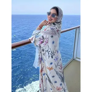 An Elegant Muslim Dress Featuring Intricate Floral Patterns Paired with a Matching Khimar Hijab. This Stylish Vacation Outfit Is Made from a Single Layer of Nida Fabric, Offering a Solid Color That Is Easy, Light, Breathable