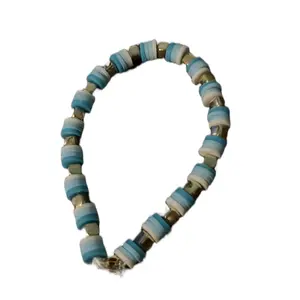 Teal bracelet with gold charms
