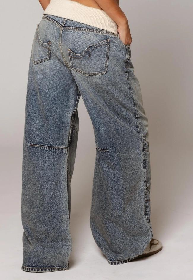 Retro street style, figure-flattering, high-waisted, washed blue denim jeans for women.