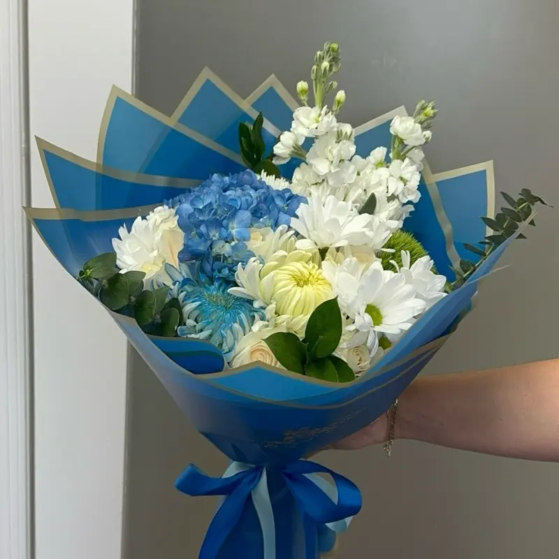 Blue Ocean Bouquet with Blue Hydrangeas White Chrysanthemums and Greenery in Blue Packaging