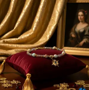 Elegant Beaded Bracelet with Star Charm and Velvet Pillow Display