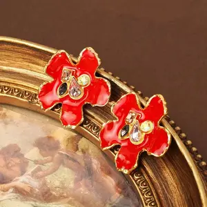 Vintage Western red enamel floral stud earrings with a textured 3D finish and intricate craftsmanship