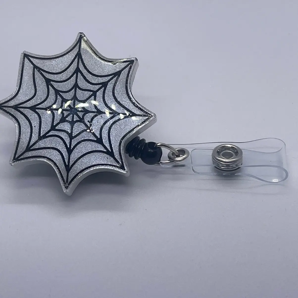 spooky white spider web badge reel