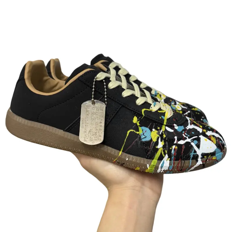 Suede low‑top retro sneakers black multicolor paint‑splatter print, lace‑up gum rubber outsole casual street‑style daily footwear
