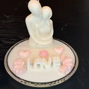 Soy Candle in the Shape of a Man and a Woman Embracing Each Other with 'LOVE' Design and Heart Accents