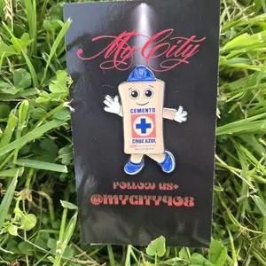 Cruz Azul Costalito Metal Pin  - Character Design with Blue Shoes and White Gloves, Featuring a Red Cross