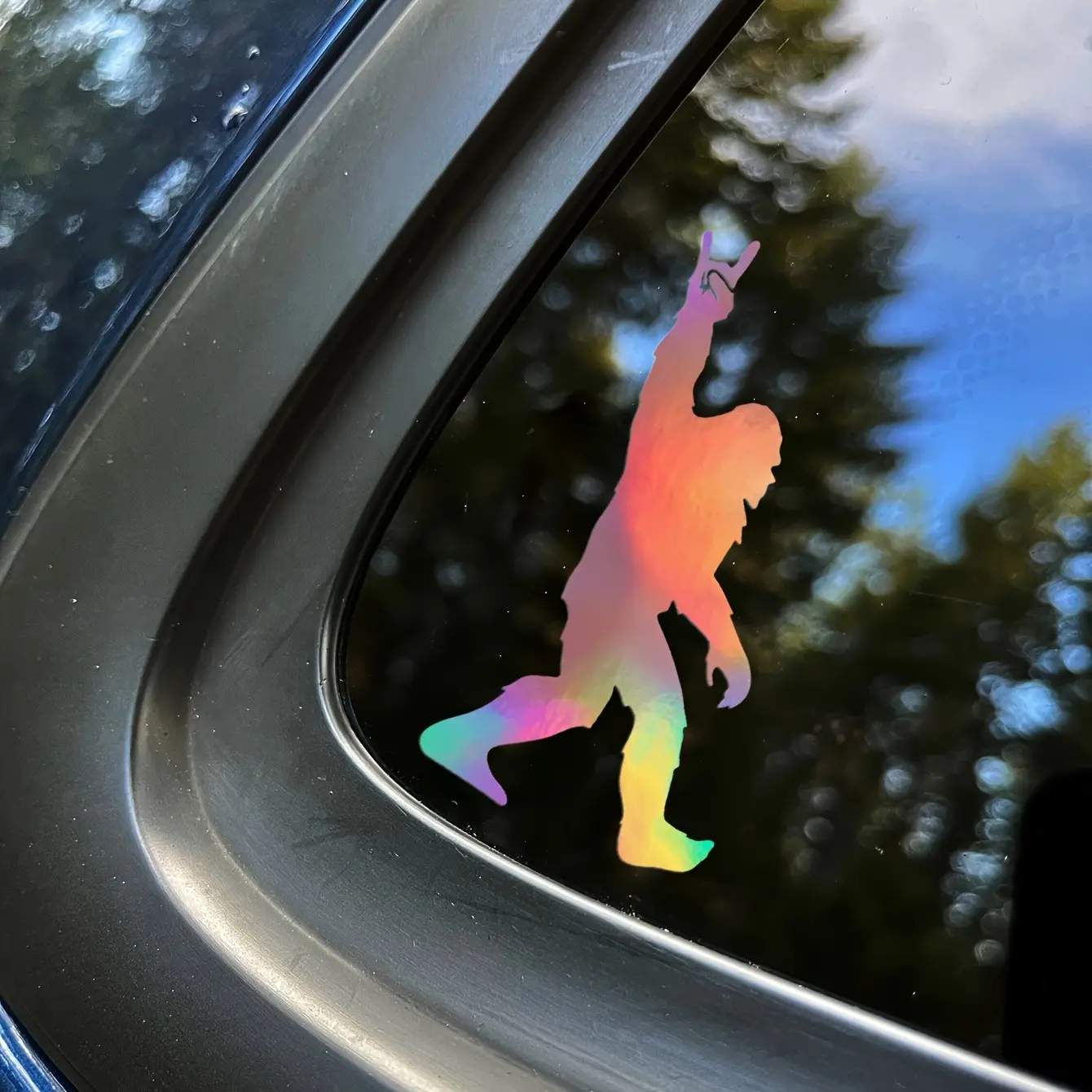 Sasquatch rockin' vinyl decal | Self-adhesive window sticker | Glossy finish | Cartoon gorilla silhouette with rock hand gesture | Durable and weatherproof | Ideal for car exteriors, vehicle decoration | Playful car accessory | Decals For Vehicles