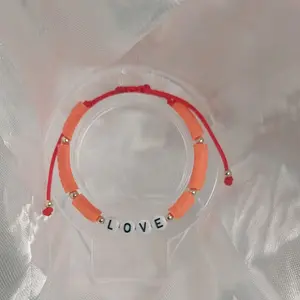 adjustable bracelet with a red string with a love charm