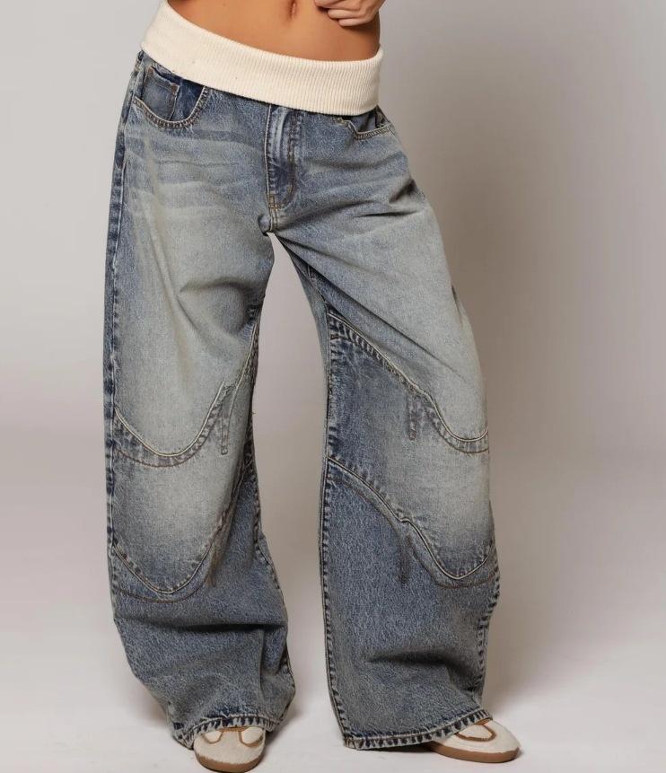 Retro street style, figure-flattering, high-waisted, washed blue denim jeans for women.