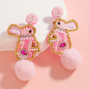Shiny pink beaded earrings, shaped like Easter bunnies, adorned with sequins and pom-poms – cute handmade hanging earrings for women, perfect for Easter celebrations or parties, featuring vibrant fluffy pom-poms