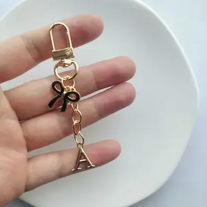 1/20pcs Elegant Bow Tie Keychain Pendant - Interlocking A-Z Letters (A-Z) with Golden-Tone Bow & Loop, Durable Zinc Alloy Chain for Keys, Bags, Backpacks