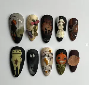 Whimsical Halloween nail art with pumpkin heads, spooky shadows, eerie frogs, sheet music drips, and autumn leaves for a hauntingly playful vibe