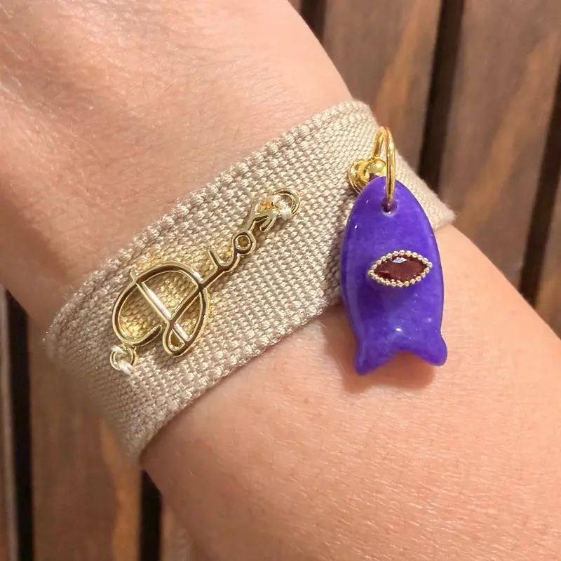 Beautiful beige bracelet featuring the Word of God and a natural stone fish charm.