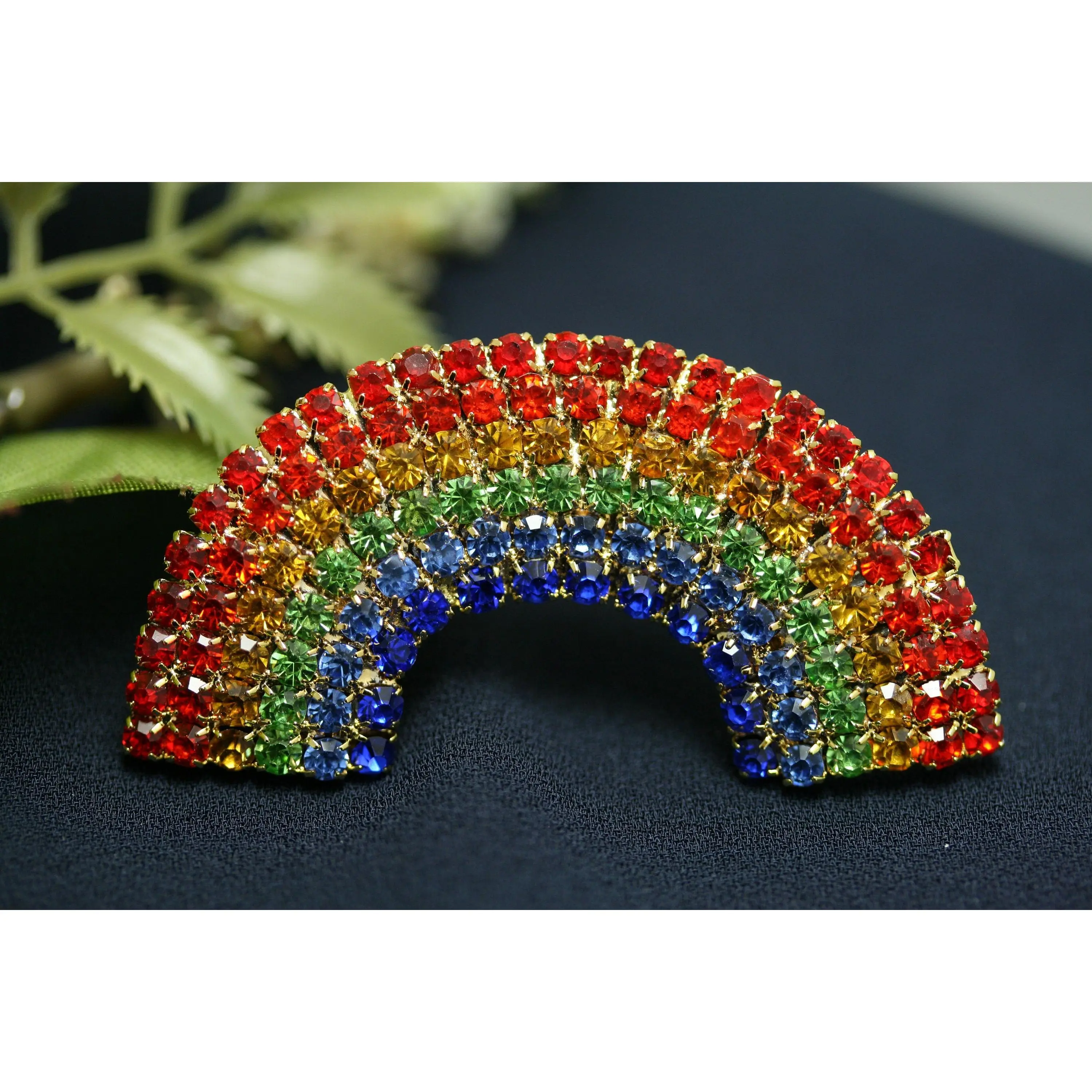 Gold-Tone Rainbow Brooch with Dense Crystals, Glamorous Statement Jewelry in a Curved Silhouette, Unisex Accessory for Jackets and Sweaters, Sparkling Stones, Rainbow Hues, Casual, Metal Coating