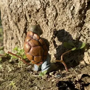 Cute Peeing Turtle Resin Ornament - A handcrafted sculpture in the shape of a humorous turtle spraying water, depicting the playful pose of a turtle standing and peeing. Suitable for garden ponds and bathroom shelves