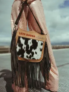 Lets Rodeo Cowboy Purse by Beth Marie Exclusive Cowhide Fringe Design with Black and White Cowhide Pattern and Fringe Detail