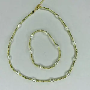 The Summertime set- 6.5" stretchy bracelet with 15” beaded necklace 3mm round gold plated hematite beads with white mother of pearl oval seed beads.