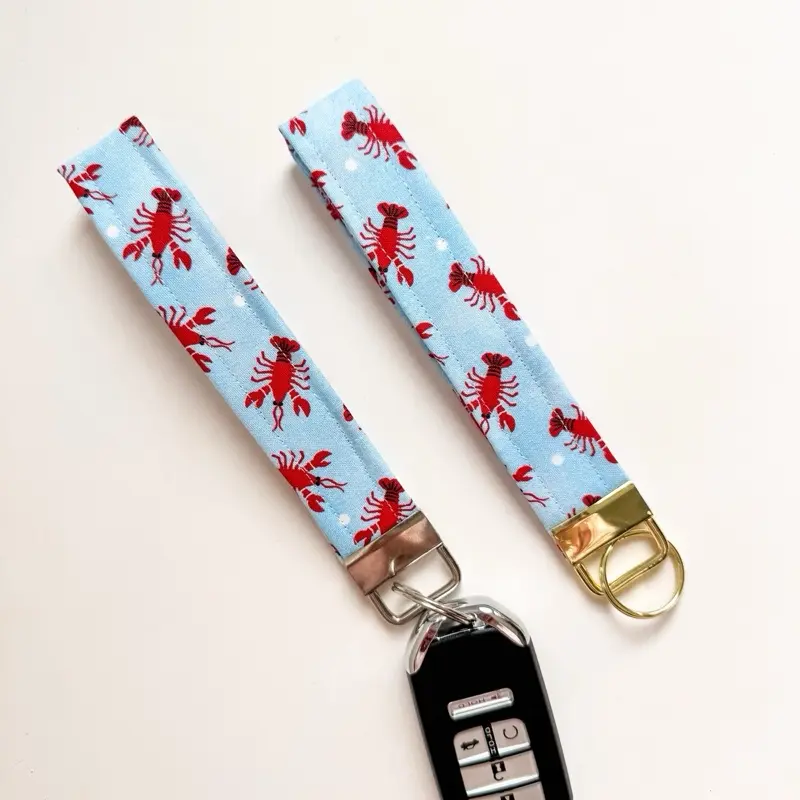 Lobster Keychain Wristlet with Red Lobster Design on Blue Background and Gold-tone Metal Clasp