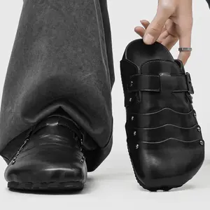 Men’s Black Wave‑Studded Leather Mules with punk‑style metal studs and wavy leather details. Adjustable buckle strap ensures customized fit, soft leather delivers all‑day comfort. Non‑slip sole offers stable wear.