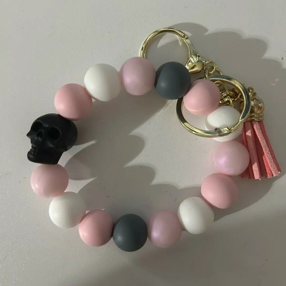 Pink shimmer skull wristlet