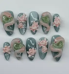 Mystic Lotus & Serpent Nails – Deep jade green base with 3D sculpted snakes and soft pink lotus flowers, evoking an enchanted pond fantasy