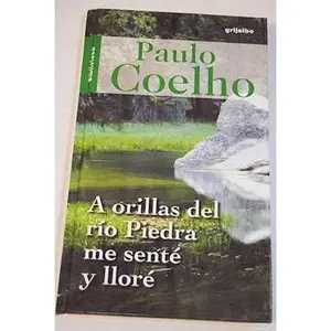 USED-A orillas del rio piedra me sente y llore (Spanish Edition) by Paulo Coelho (Hardcover)