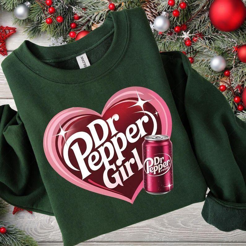 [Sale Up To 50%] Dr. Pepper Girl Hoodie/T-shirt/Sweatshirt, Fun Soda Lover Gift, Heart-Shaped Dr. Pepper Graphic, Cute Vintage Pop Culture Design for Women, Dr. Pepper Fan Apparel.