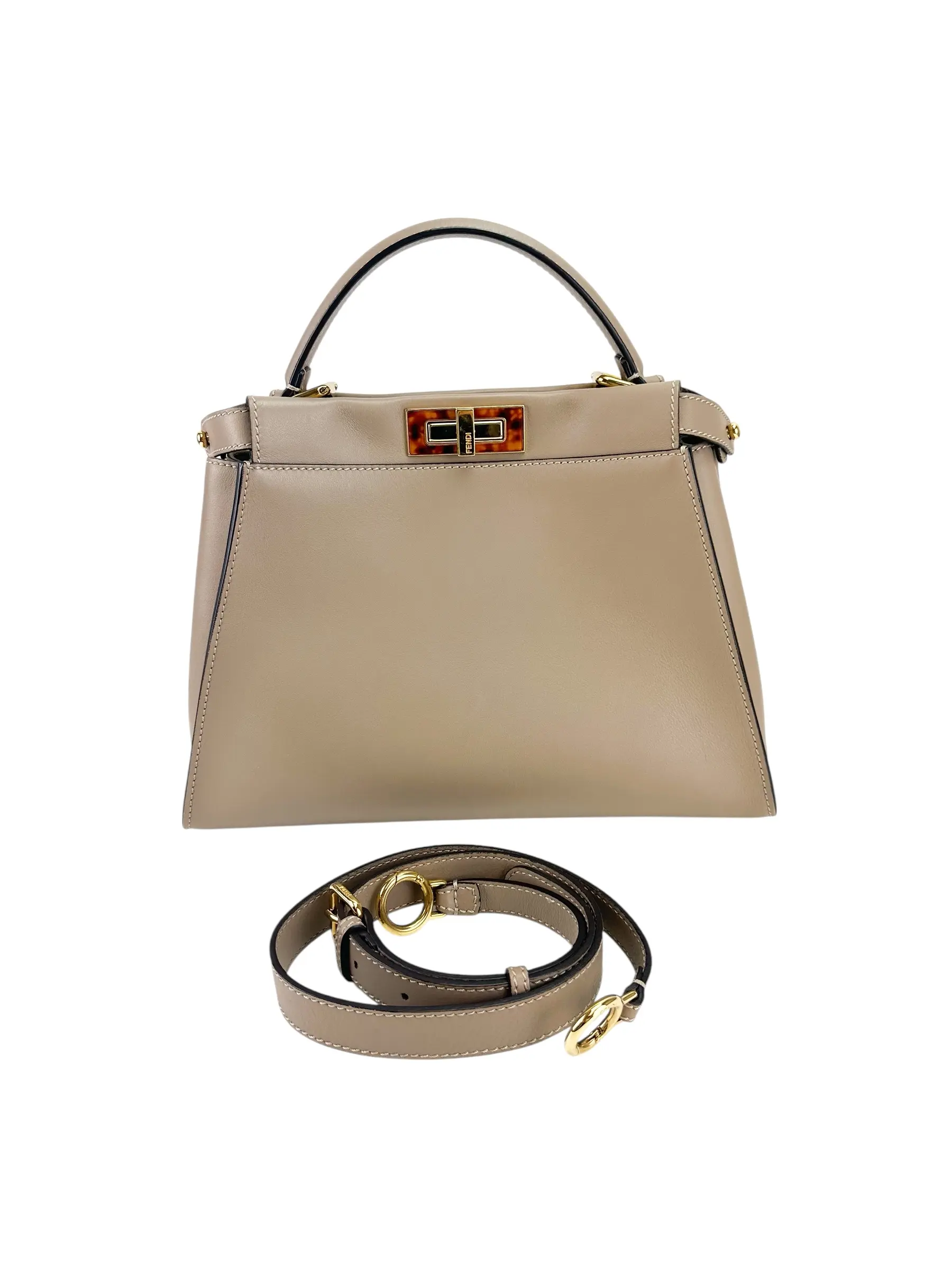 Pre-owned FENDI Light brown leather with gold tone hardware. Twist closure on both sides with Fendi logo. Shoulder Bags LIGHT BROWN PEEKABOO ESSENTIALLY BAG