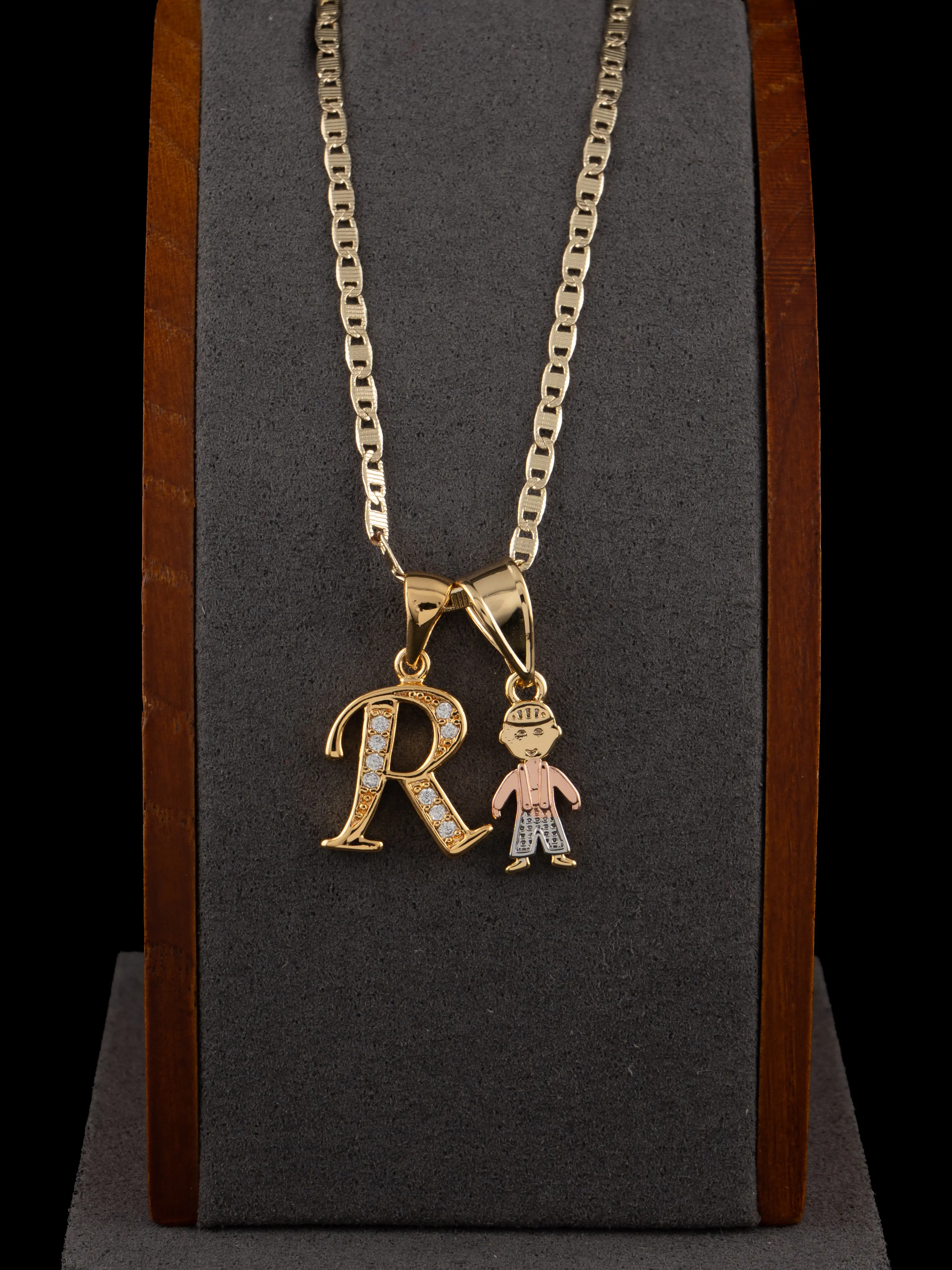 Exclusive boy or girl pendants with an initial in gold laminate; includes an 18 or 24-inch chain.