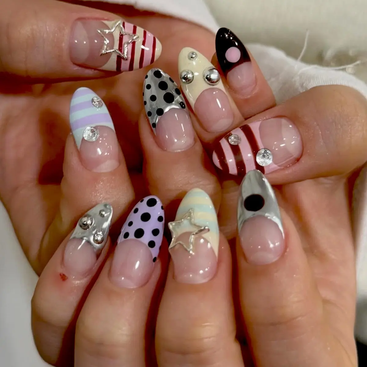 24 pcs medium-length almond tips nails, Glossy false nails, Nail Art, Nail Designs, Y2K nails style with black polka dots, rainbow pink color blocking, French tips design, paired with metal five-pointed stars, Rhinestones