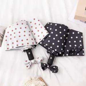 A simple and elegant black and white polka dot tri-fold umbrella a mini fully automatic UV-protective sun umbrella