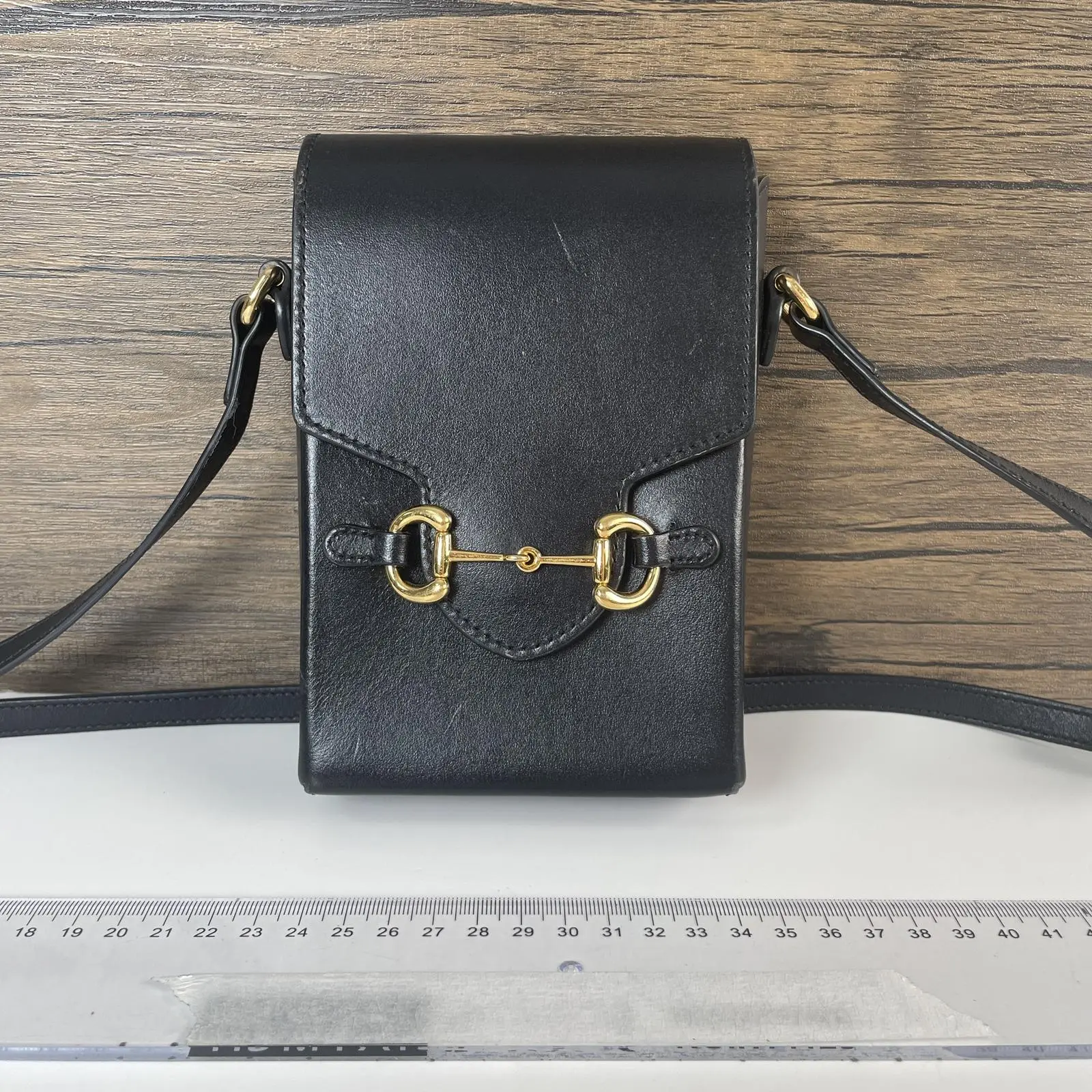 Pre-owned GUCCI leather Crossbody bags 1955 Horsebit Phone Crossbody Bag, black smooth calfskin leather, iconic gold tone horsebit hardware, adjustable thin crossbody strap, flap closure+++chain+++
