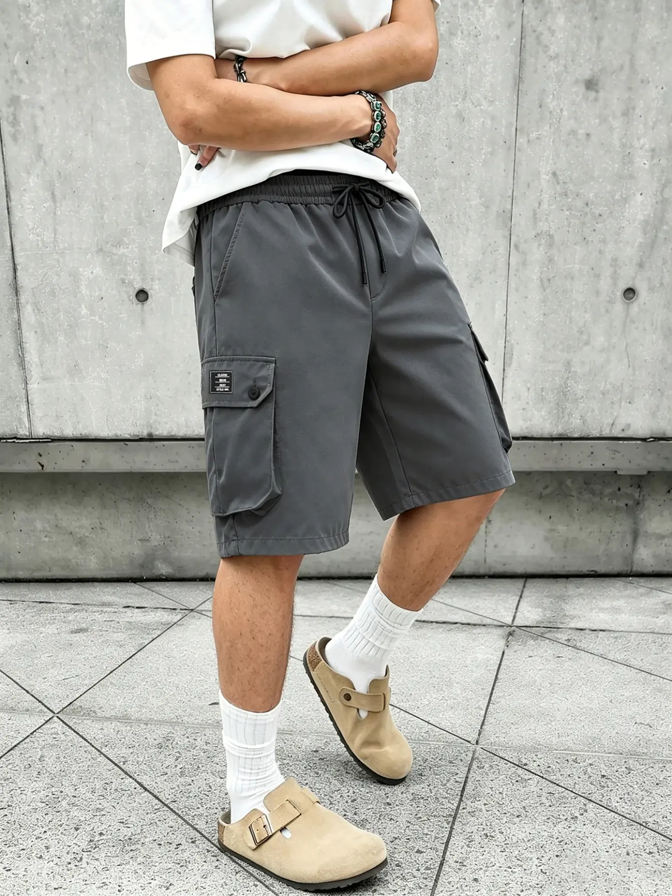 Men’s street-style wide-leg cargo shorts, gray, large side cargo pockets, tear-resistant and wear-resistant fabric, mid-length silhouette, suitable for skate style, hip-hop outfits, and summer streetwear looks.