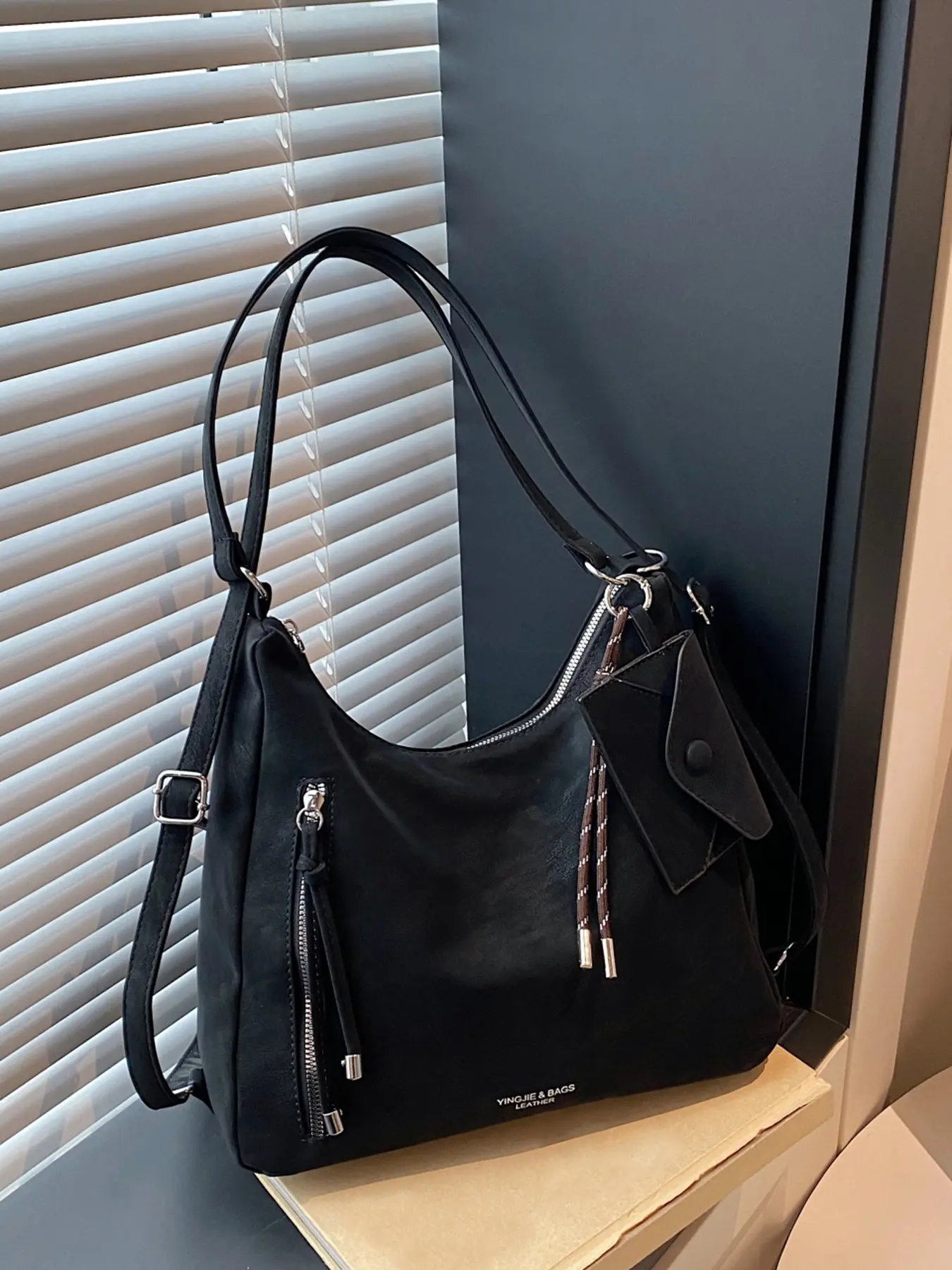 Functional style dark color texture underarm bag, multi pocket design, with woven rope hanging decoration, retro multi back single shoulder crossbody bag, Fashionable shoulder bag, Cross Body Bags, suitable for commuting and gatherings