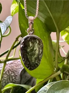 Authentic Moldavite Pendant with Necklace: A 4.7 grams genuine celestial gem, verified for authenticity. Embrace cosmic energies, deepen your spiritual connection, and leap to a transformation journey. Elevate your style and consciousness now.