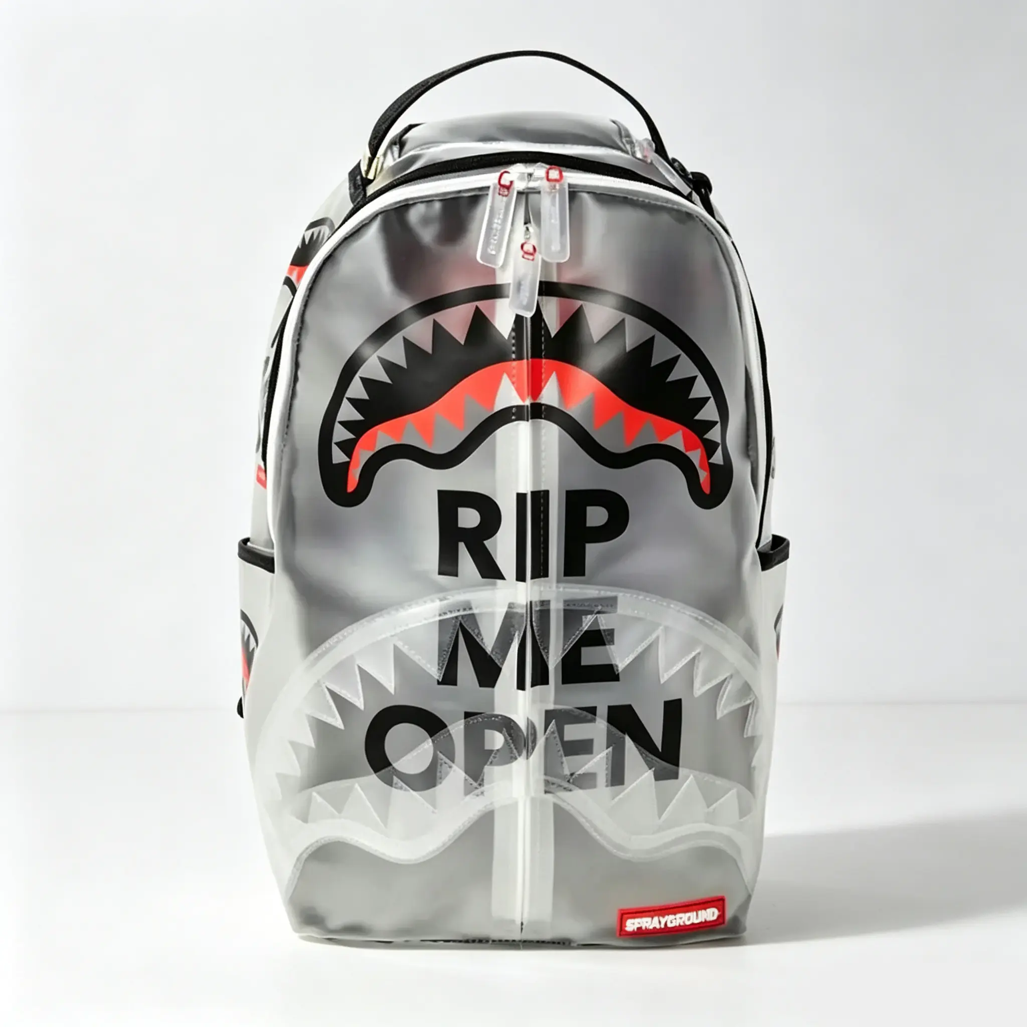 Sprayground Rip Me Open Backpack - Silver Color with Bold Shark Design and "Rip Me Open" Text - Perfect for Daily Use