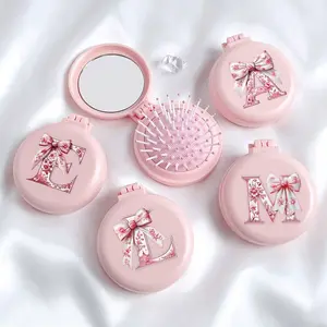 Pink Bowknot 26-Letter Round Folding Comb with Mirror — Portable 2-in-1 Makeup Mirror & Comb — Mini Foldable Air-Cushion Massage Comb | Ideal for Weddings, Travel, Office, & Outings | Mother's Day Gift & Travel Essential