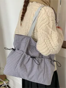 Japanese-style lightweight canvas tote bag with an Instagram vibe, large capacity, double-layer shoulder bag, Casual Commuter Bag, simple and versatile, perfect for commuting, work, shopping, and everyday accessories. Features a magnetic closure.